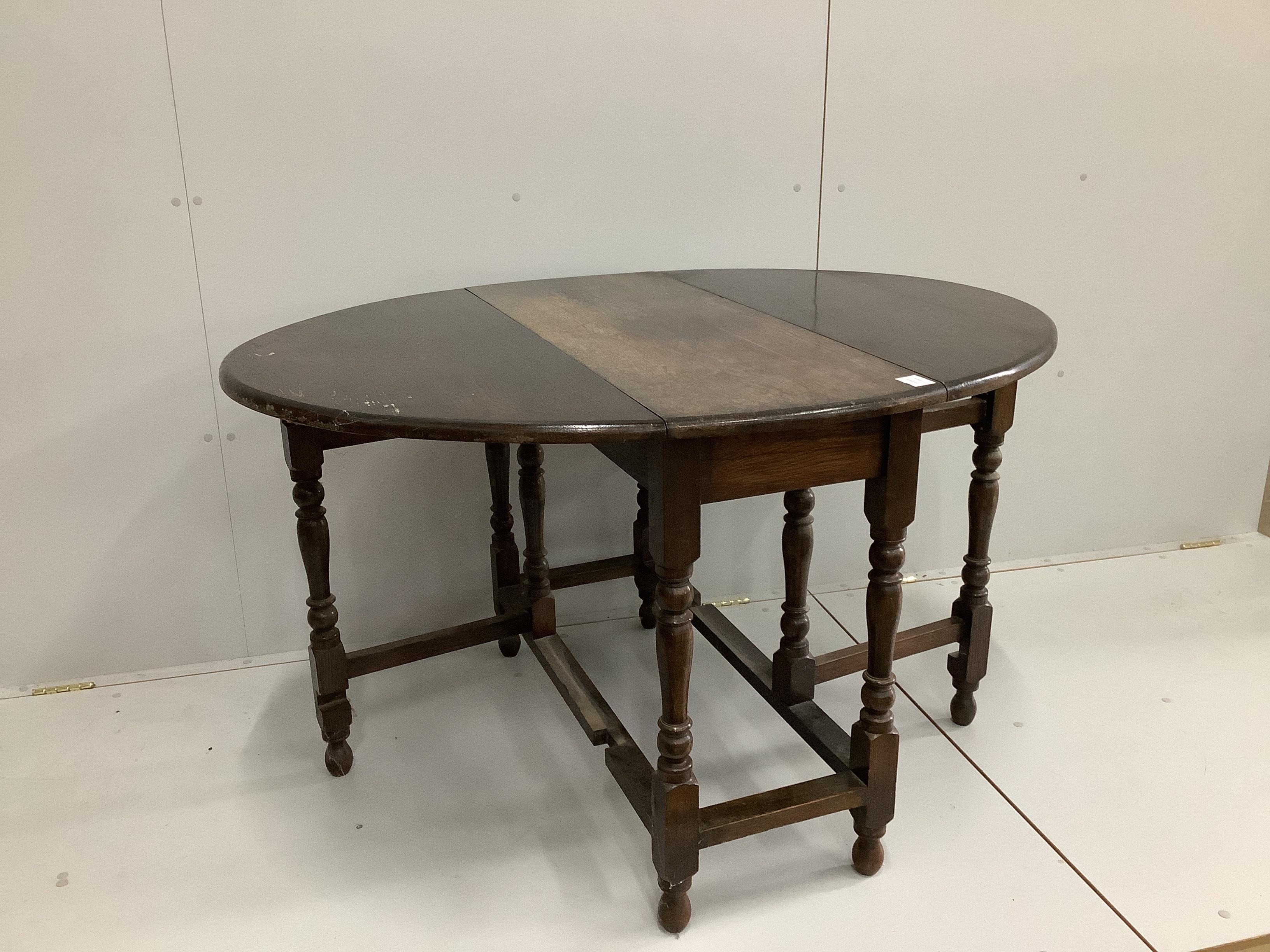 An 18th century style oak gateleg dining table, width 98cm, depth 42cm, height 75cm